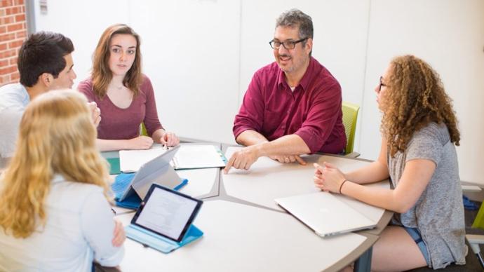 Jonathan King sits around a table with other students. 