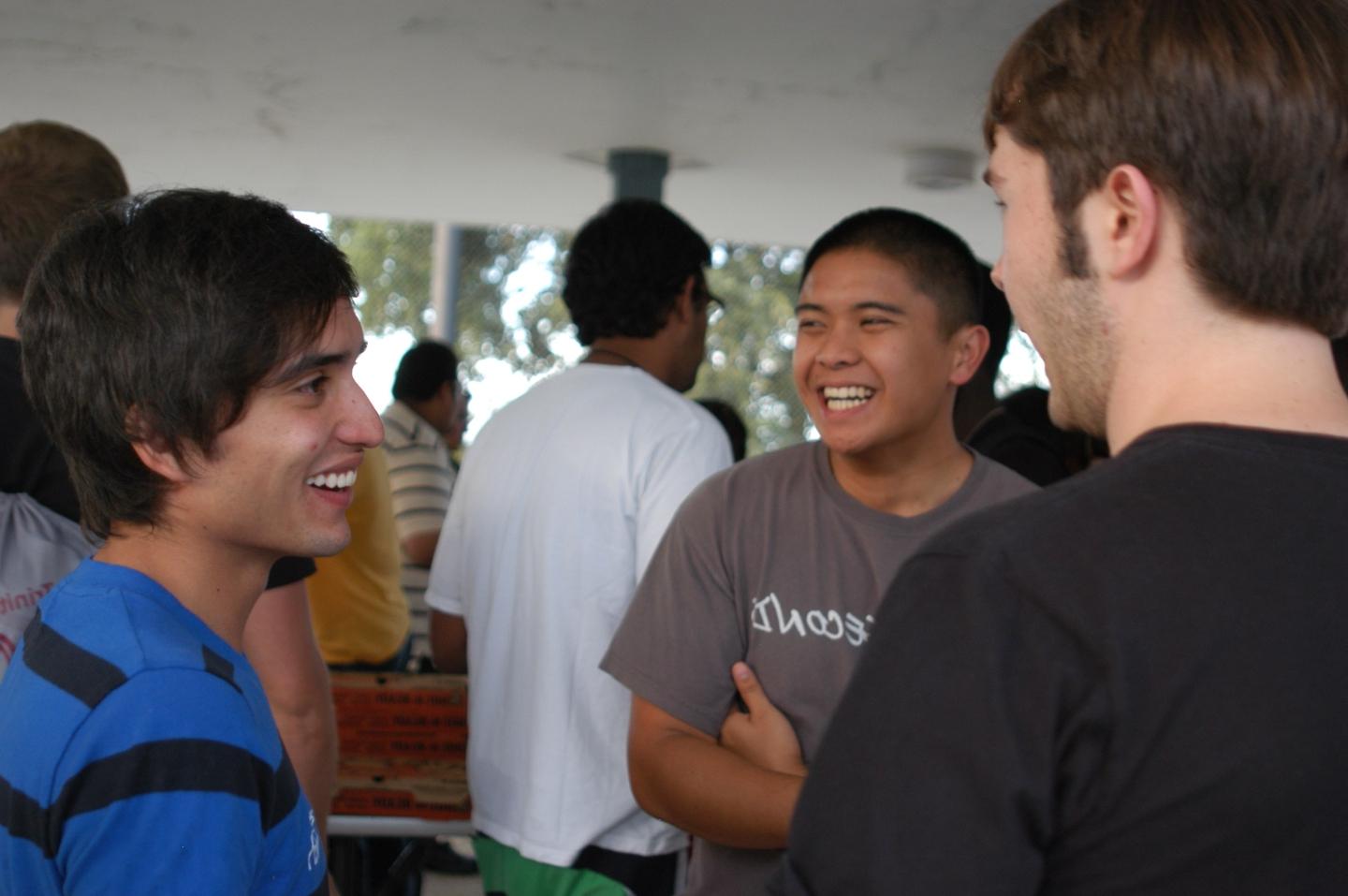 Students talking together in a group at an International Student Pool Party. 